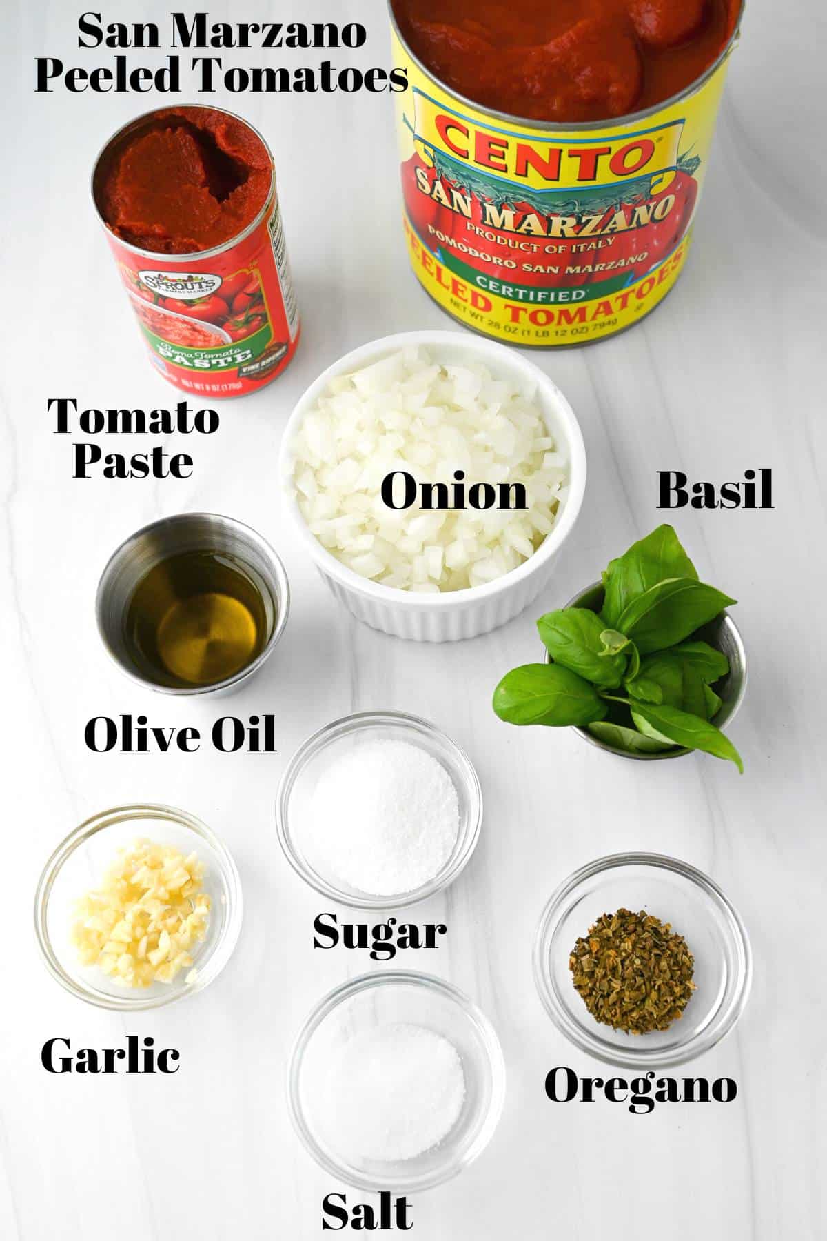 ingredients for san marzano pizza sauce measured out on a white counter