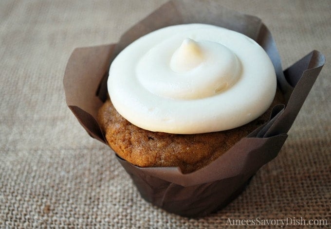 A close-up of a frosted pumpkin cupcake 