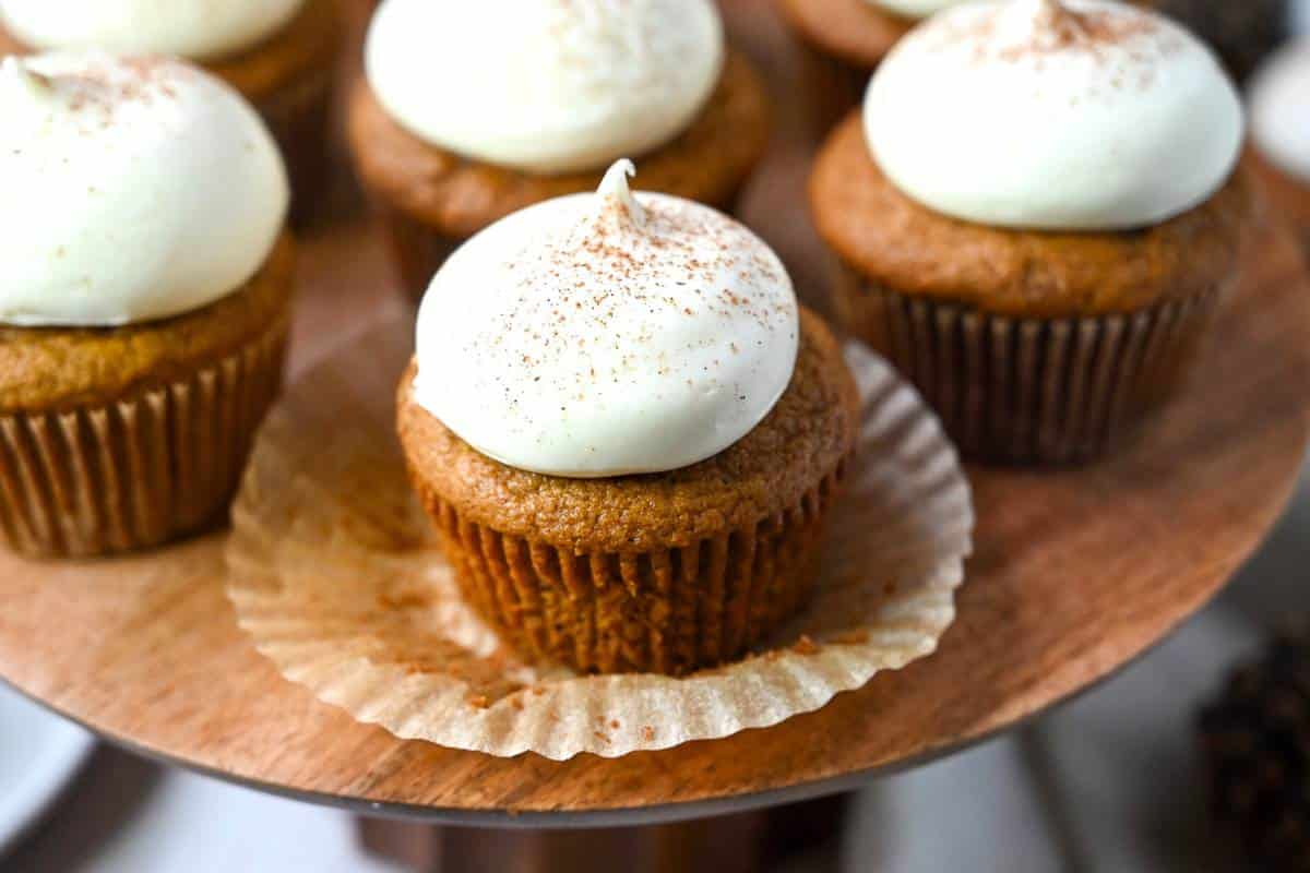 a cupcake with the liner pulled back on a platter