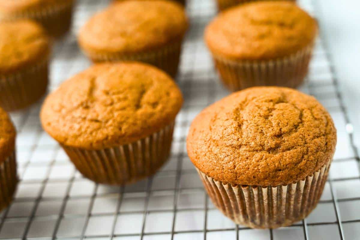 pumpkin cupcakes cooling on a baking rack