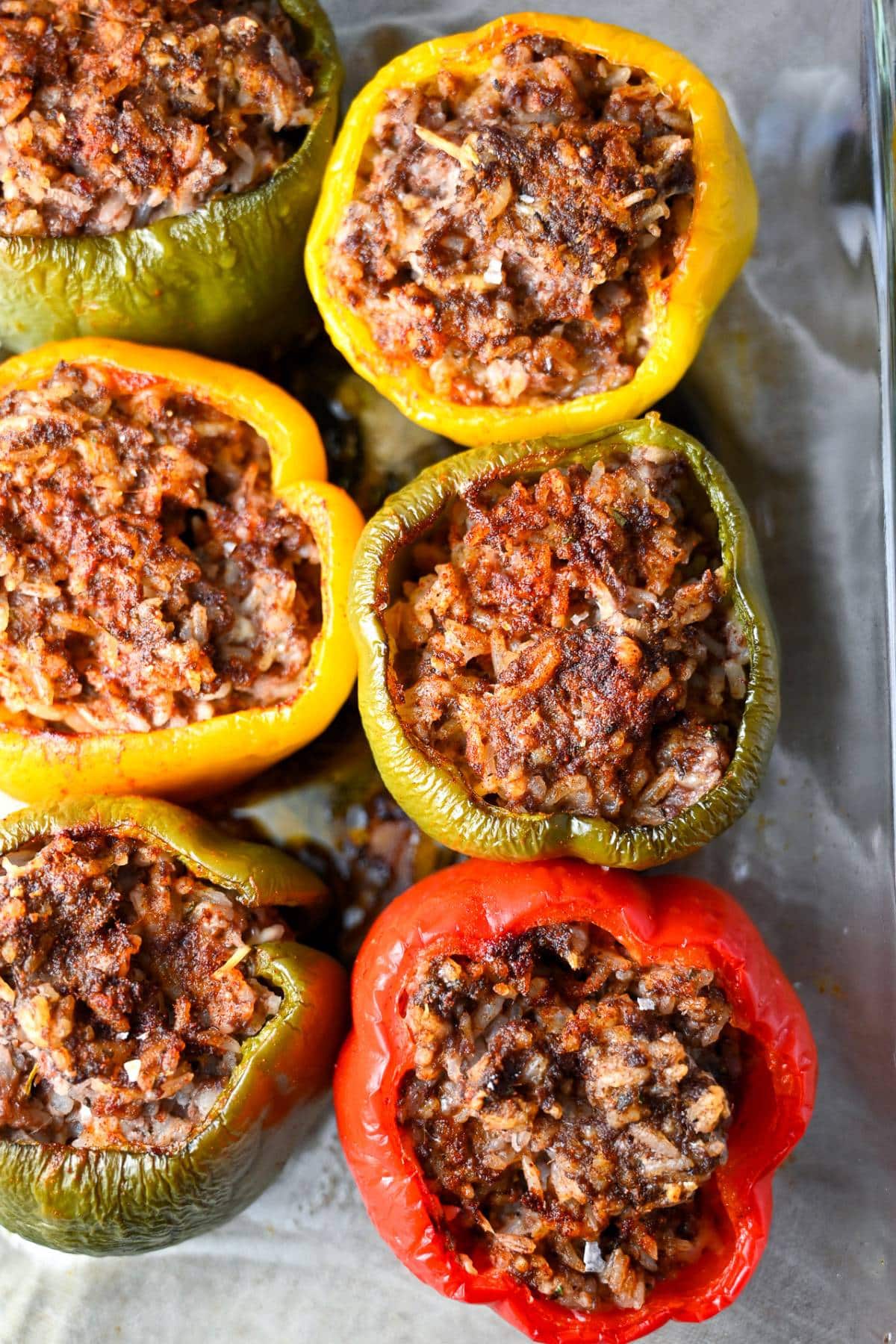overhead photo baked stuffed peppers in a clear dish