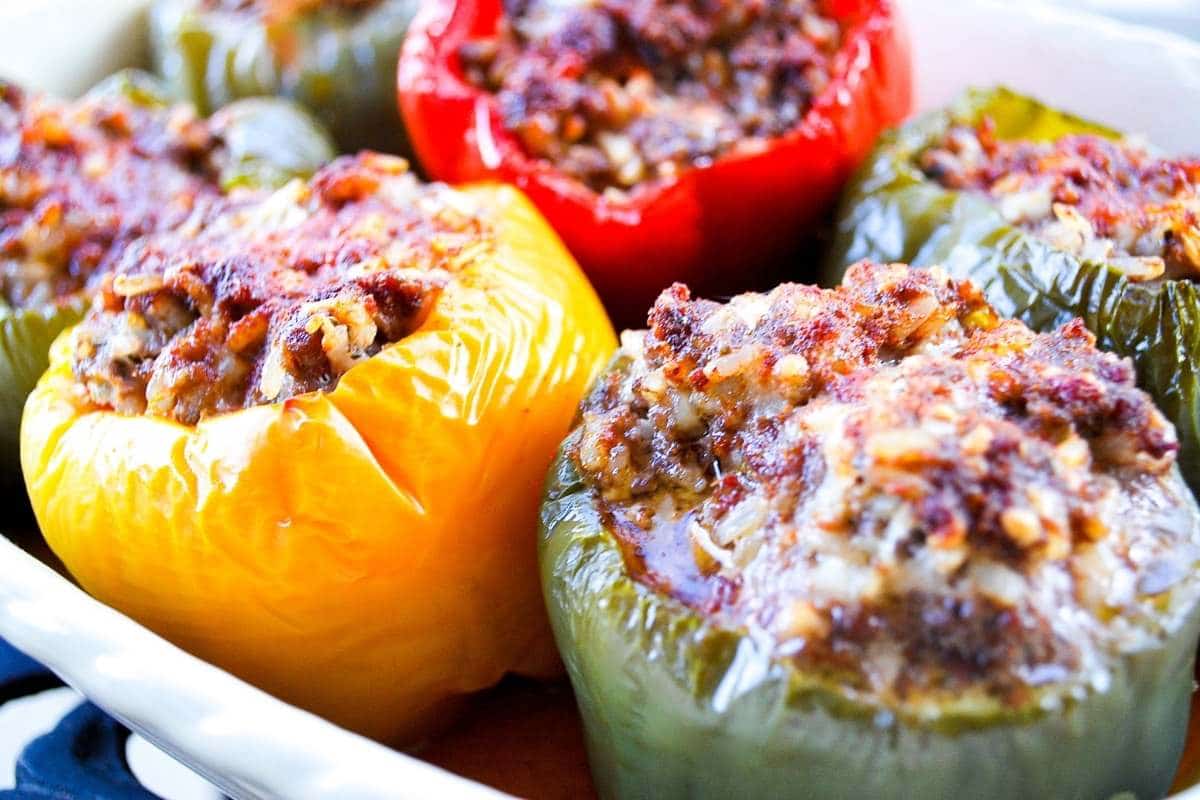 close up photo of stuffed peppers in a baking dish