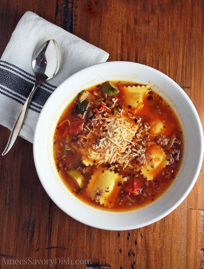 bowl of italian sausage soup with napkin and spoon