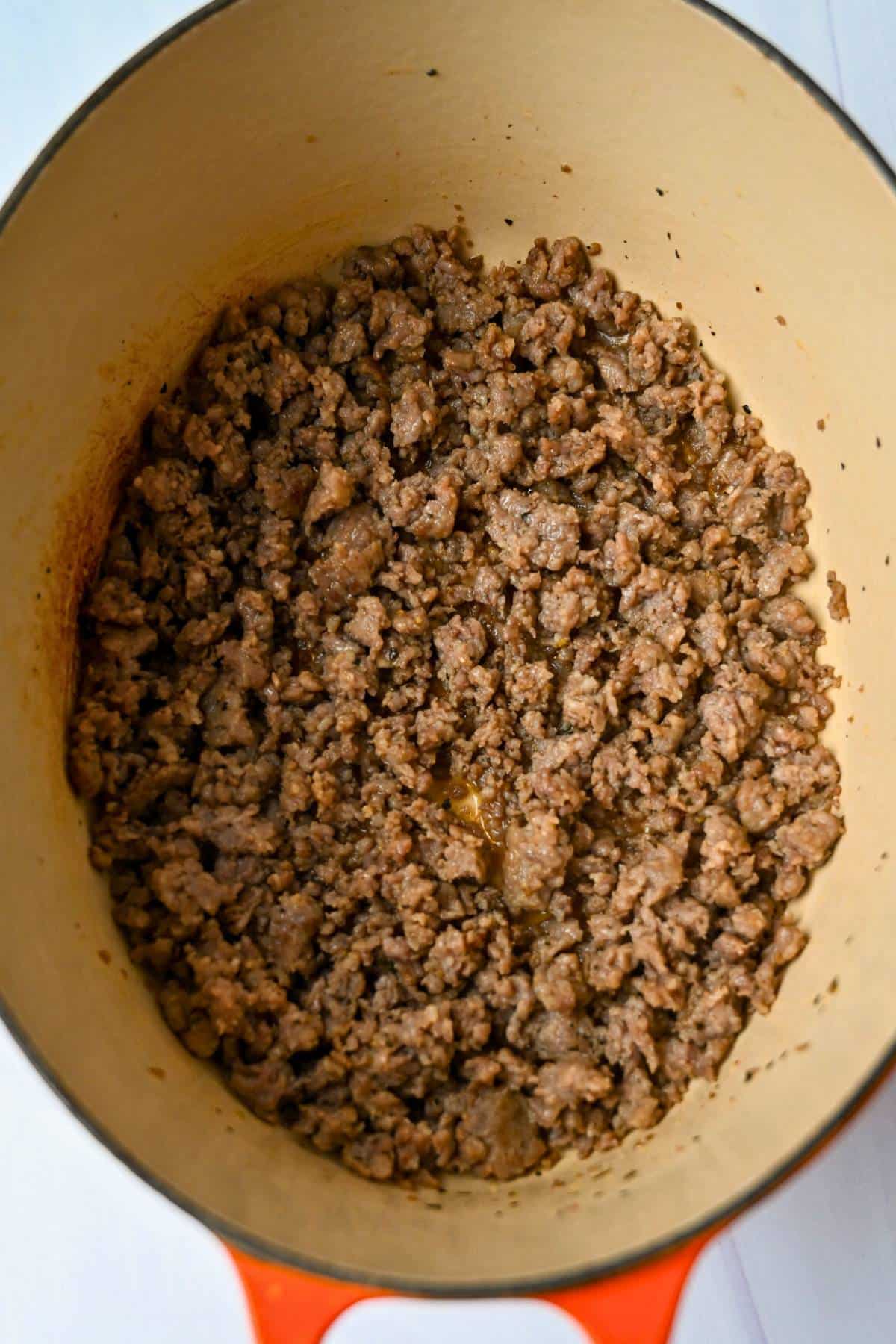 browned Italian sausage in a dutch oven