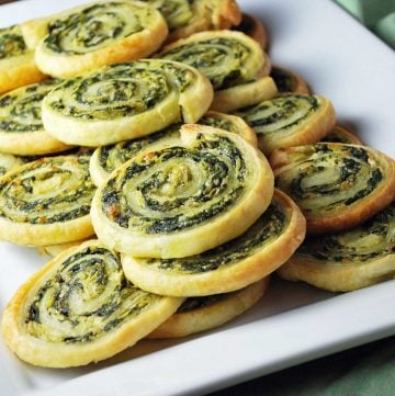 white platter filled with sliced spinach pinwheels that have been freshly baked