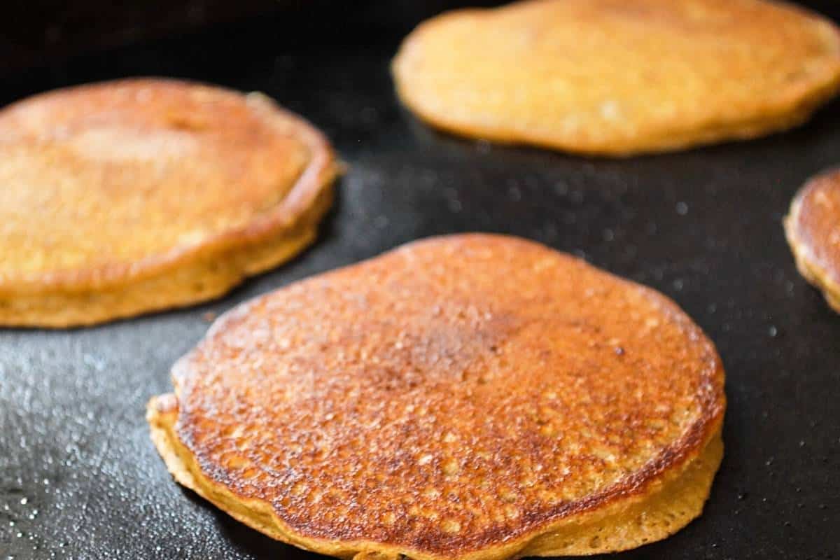 cooked pancakes on a Blackstone griddle ready to plate