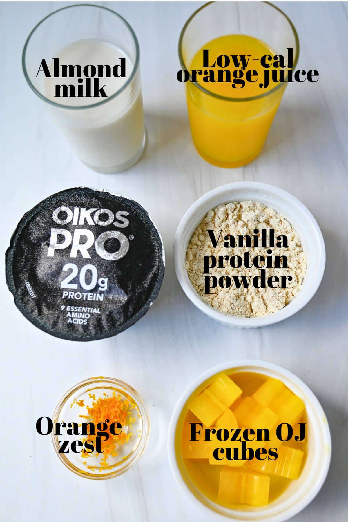 ingredients for making an orange creamsicle smoothie measured out on a counter