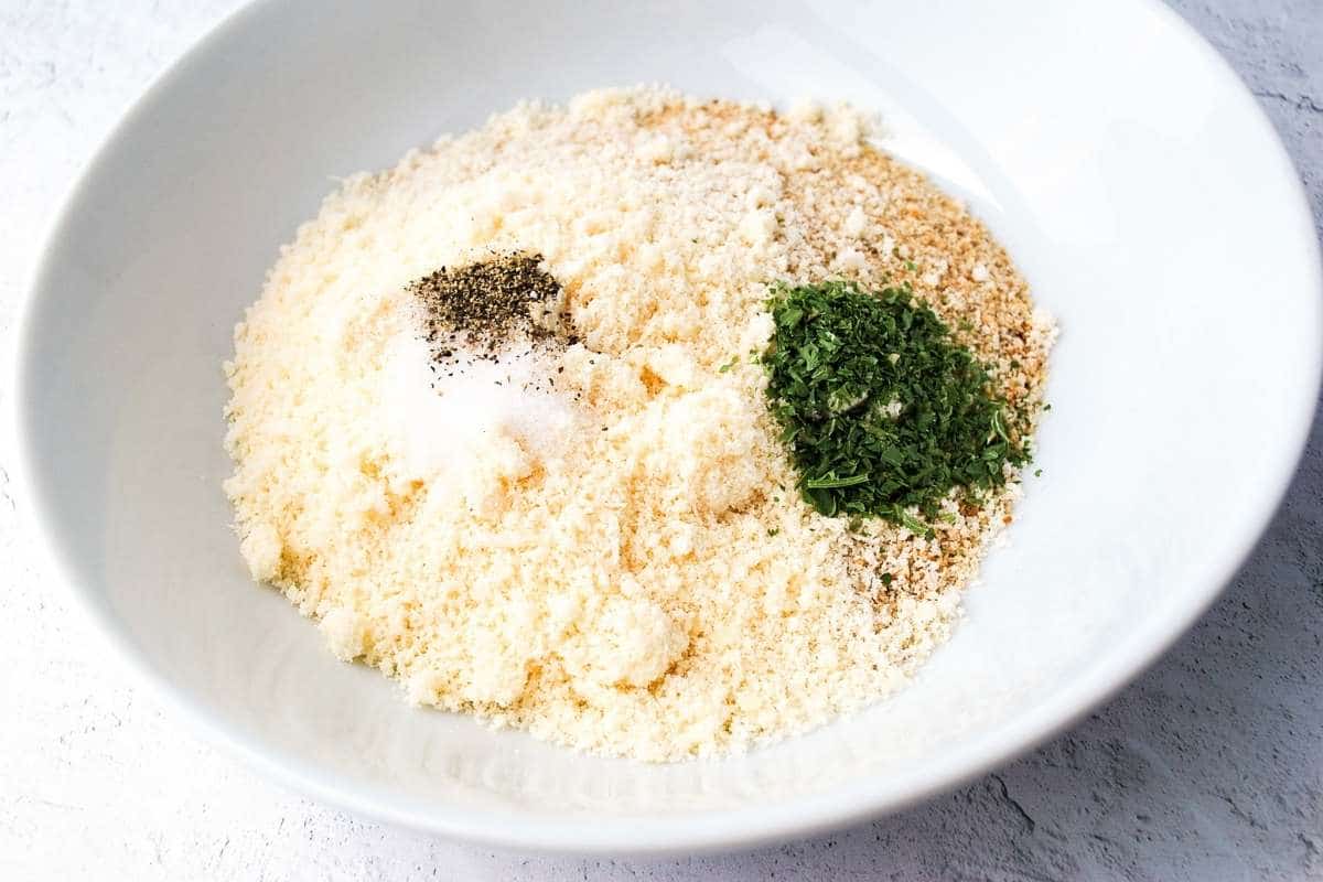 dry ingredients for parmesan crusted chicken in a white bowl