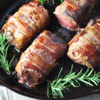 Bacon-wrapped venison loin with raspberry sauce