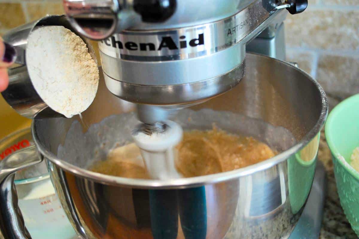 pouring flour in a mixing bowl