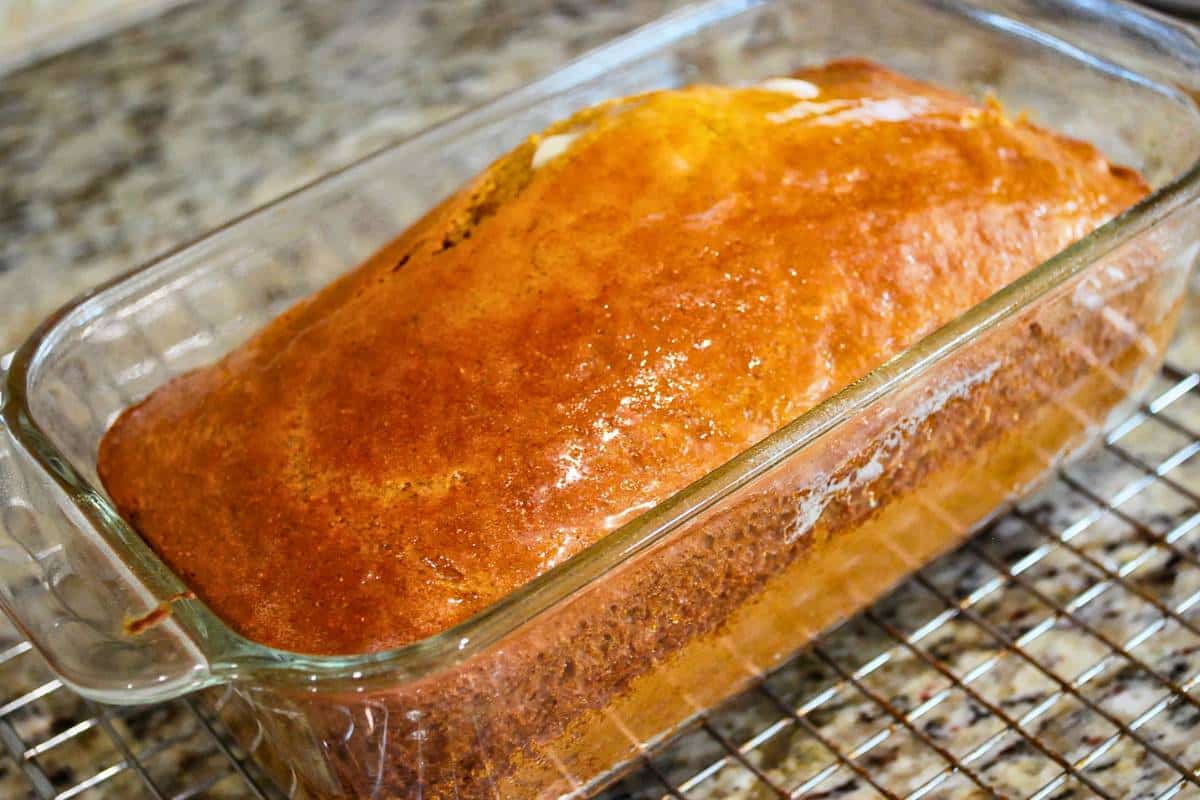 freshly baked graham flour bread topped with melted butter