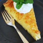 a slice of crustless coconut pie and a fork on a plate