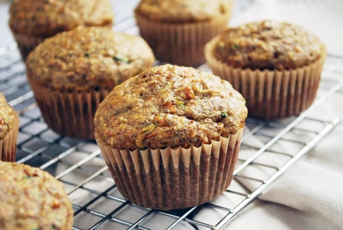 Zucchini bran muffins on a rack with napkin tucked underneath