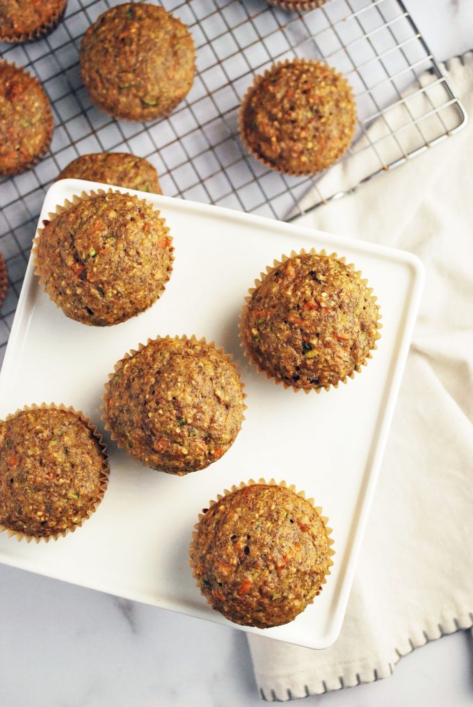 zucchini bran muffins on a plate with rack of muffins in the background