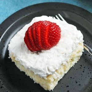 slice of coconut cake with a strawberry on top