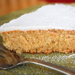 close up of a slice of Queen cake dusted with powdered sugar with a fork