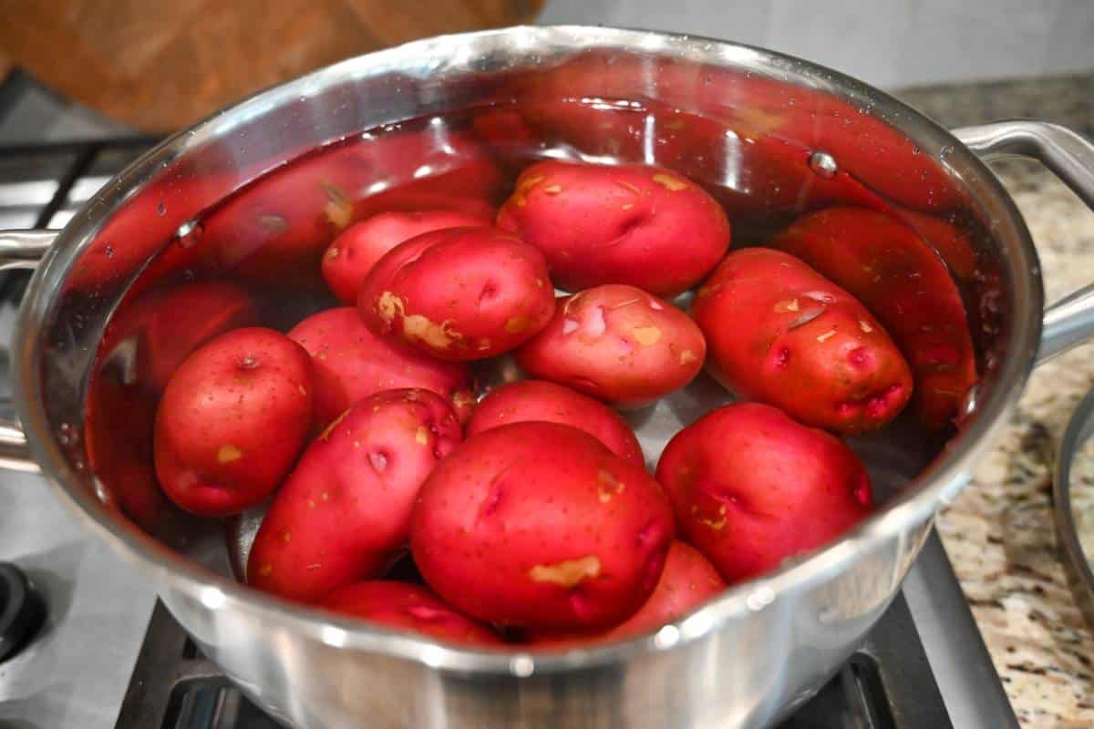 red potatoes in cold water in a pot on the stovetop
