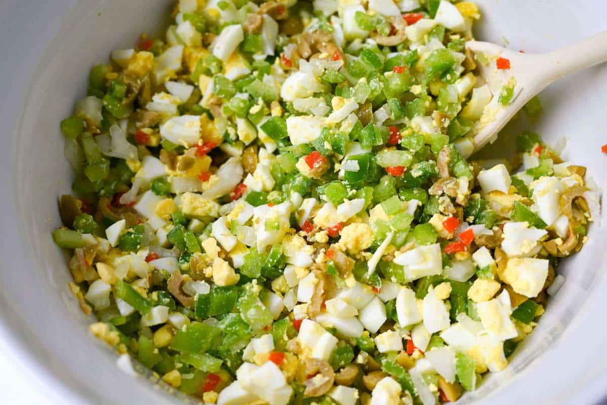 vegetables and potatoes for potato salad combined in a white bowl