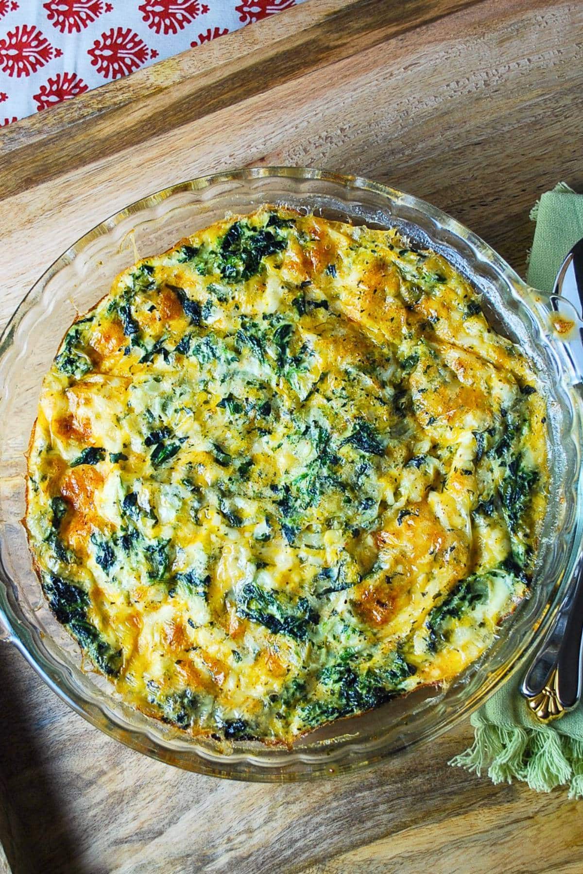 a baked cottage cheese spinach quiche on a platter