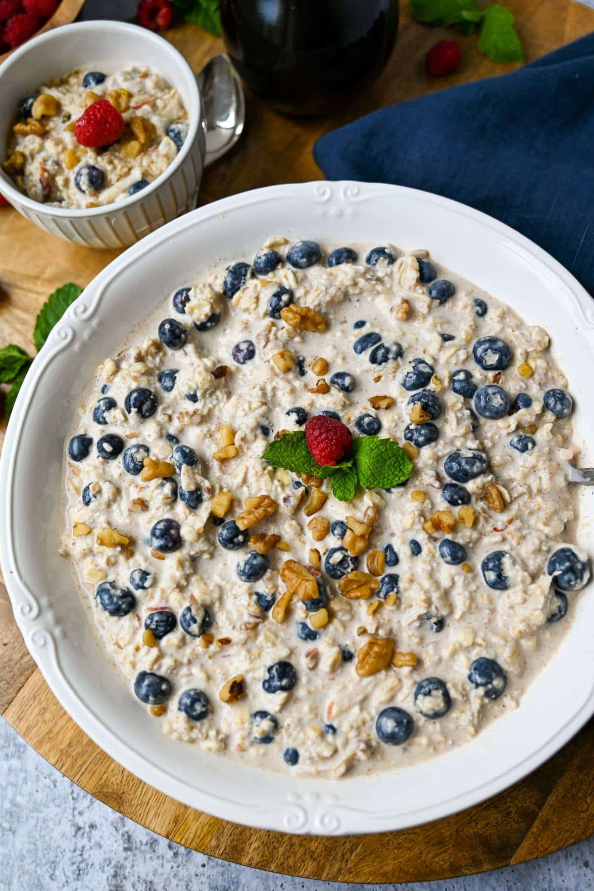 overhead photo of a large bowl of bircher muesli with fresh berries and nuts