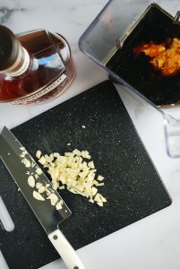 Garlic chopped on a black cutting board