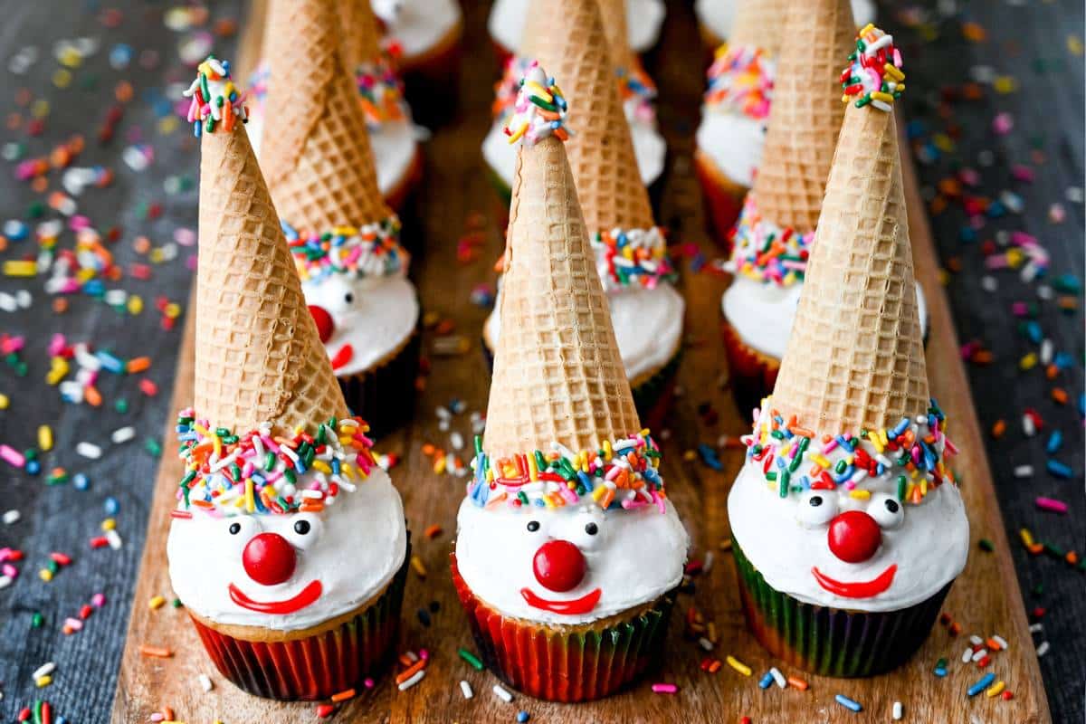 clown cupcakes with sugar ice cream cones dipped in candy melts and covered in sprinkles