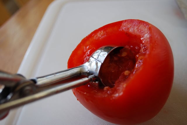 scooping out a tomato