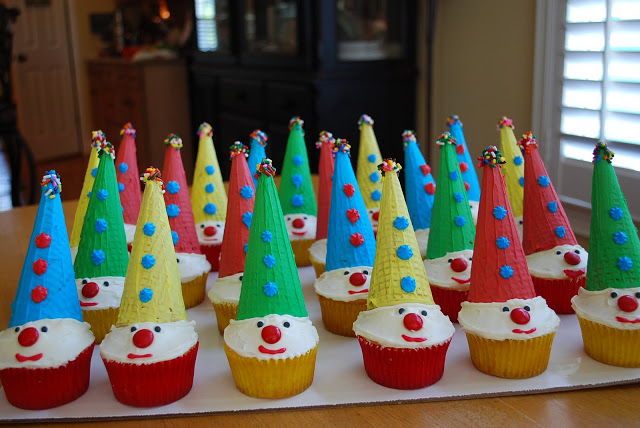 Clown cupcakes on a tray with assorted colored hats