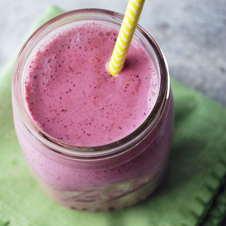 overhead photo of berry smoothie looking down on the top of the glass