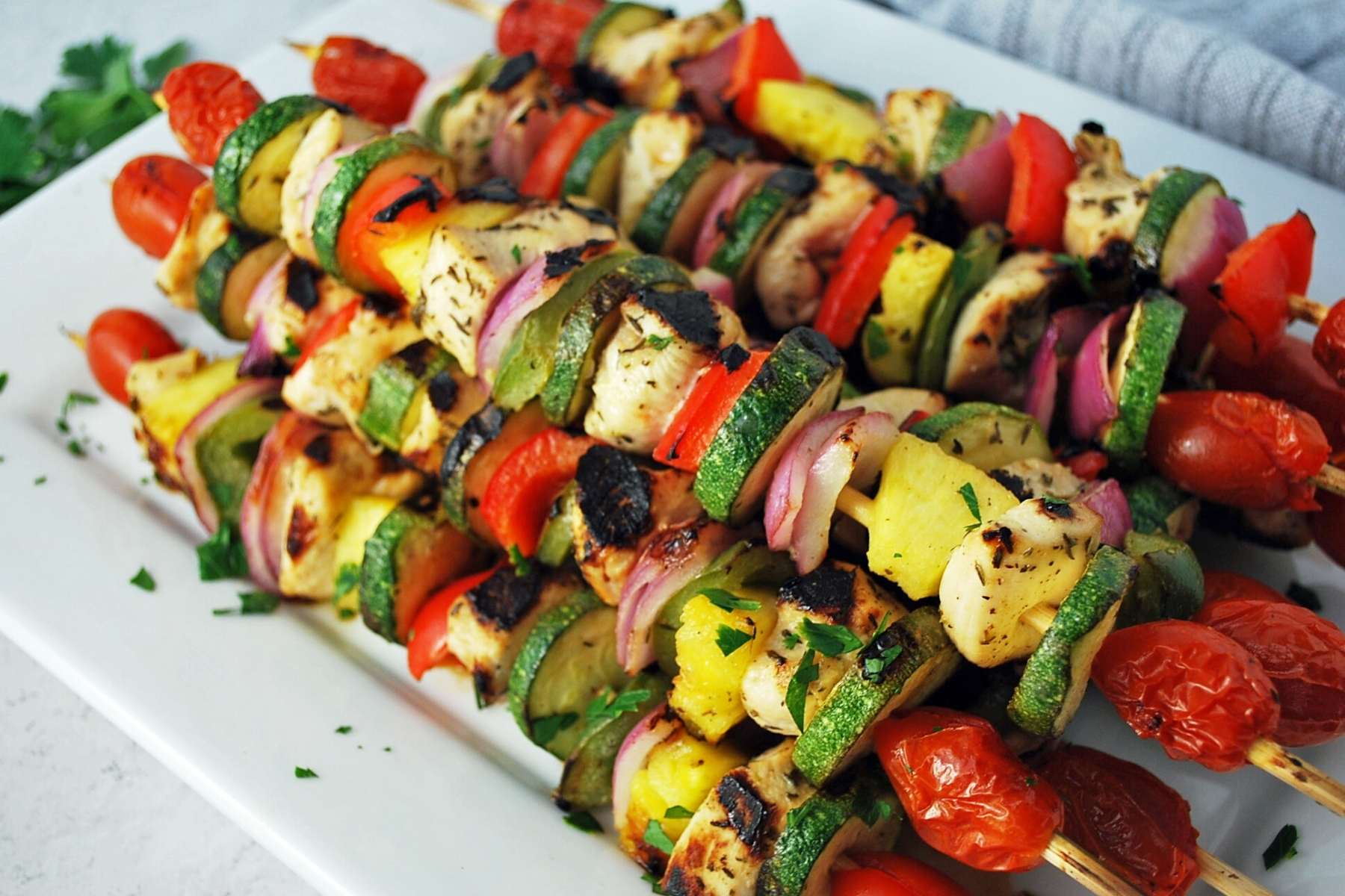 side view of a platter of chicken kabobs