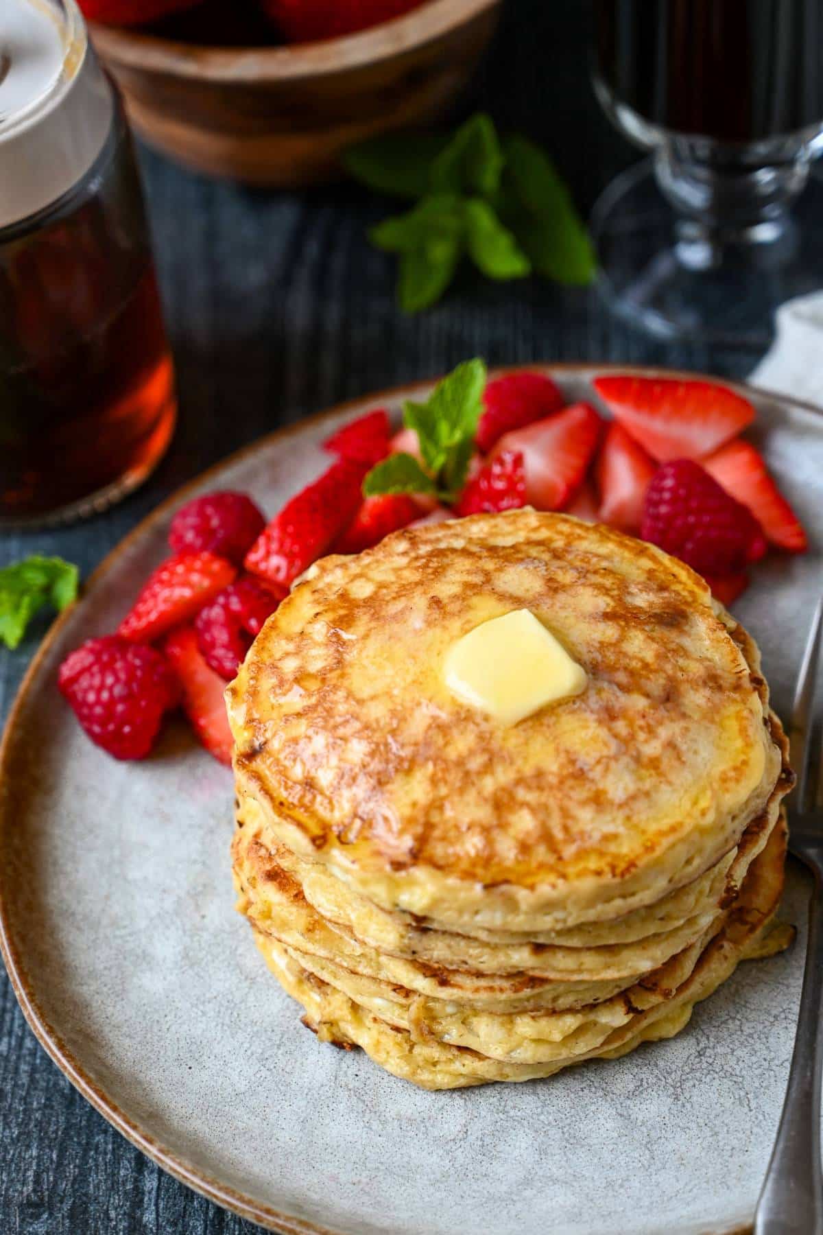a stack of gluten free high protein cottage cheese pancakes with a pat of butter on top