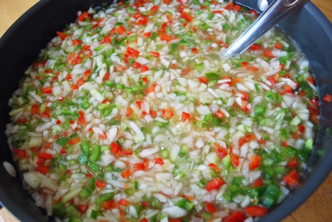 Cucumber relish in a pan with a spoon