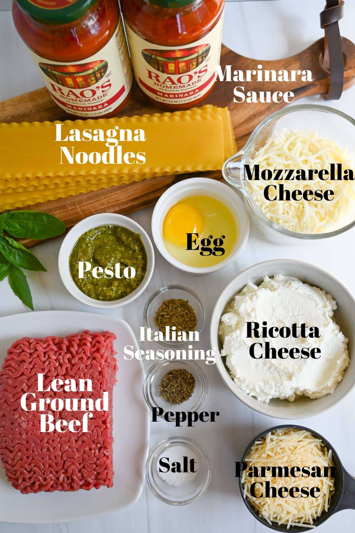 ingredients for making lasagna with ground beef and pesto sauce measured out on a counter