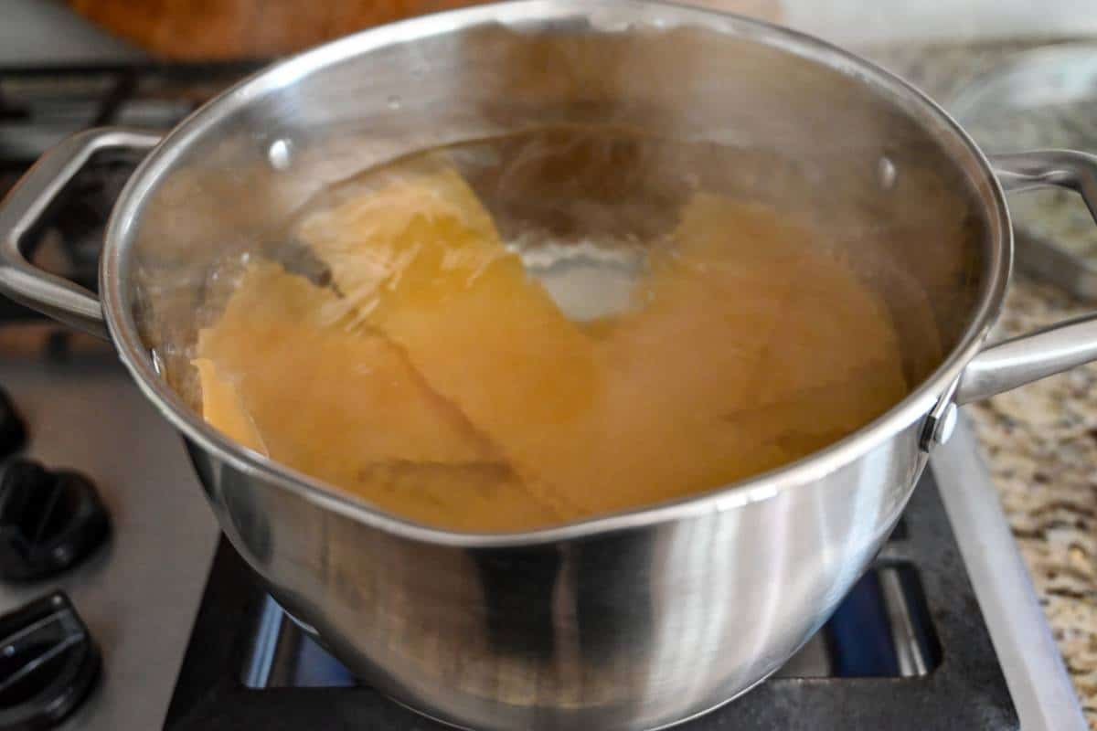 boiling lasagna noodles in a pot of water on the stove