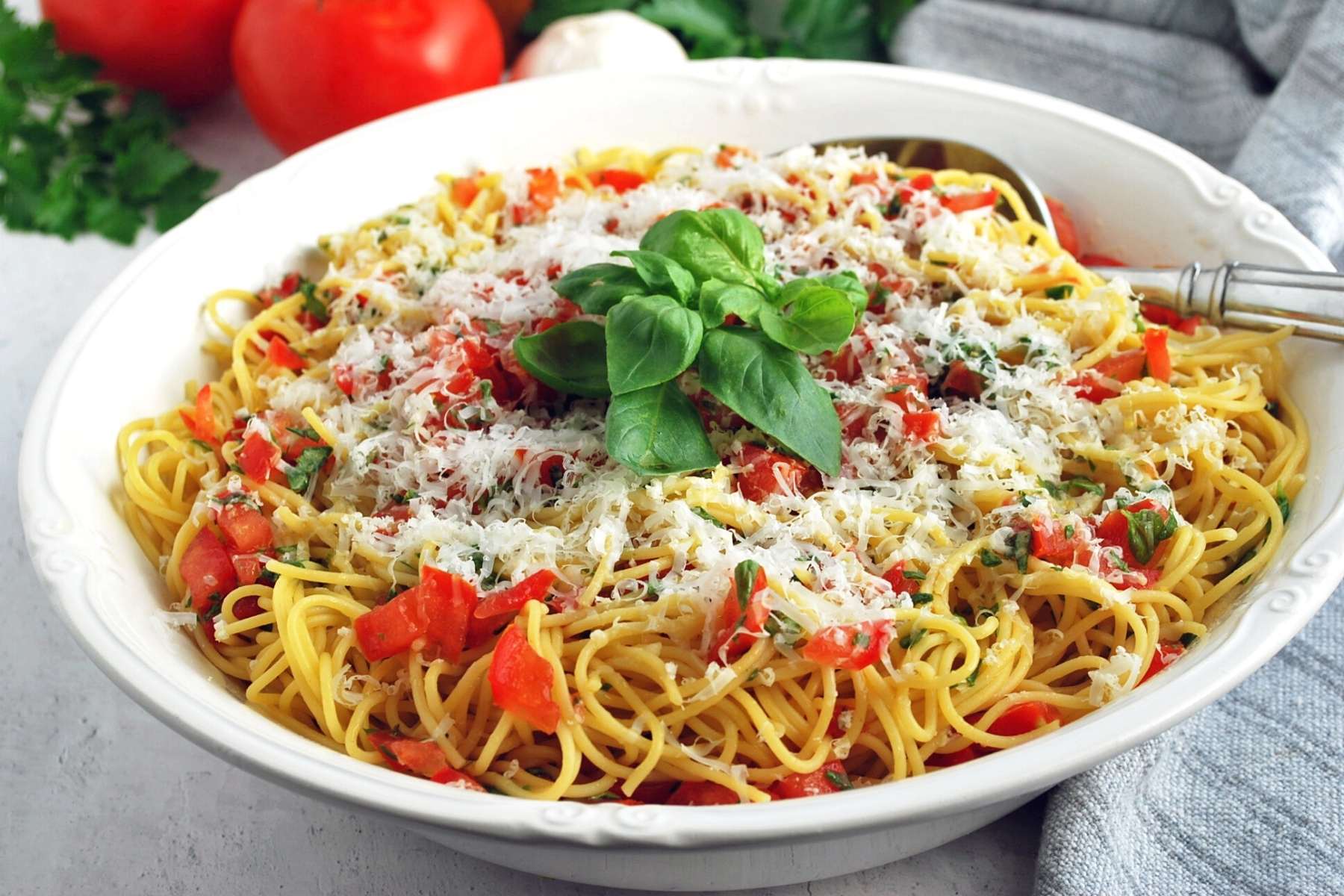 bowl of fresh pasta with tomato basil sauce with a napkin on the side