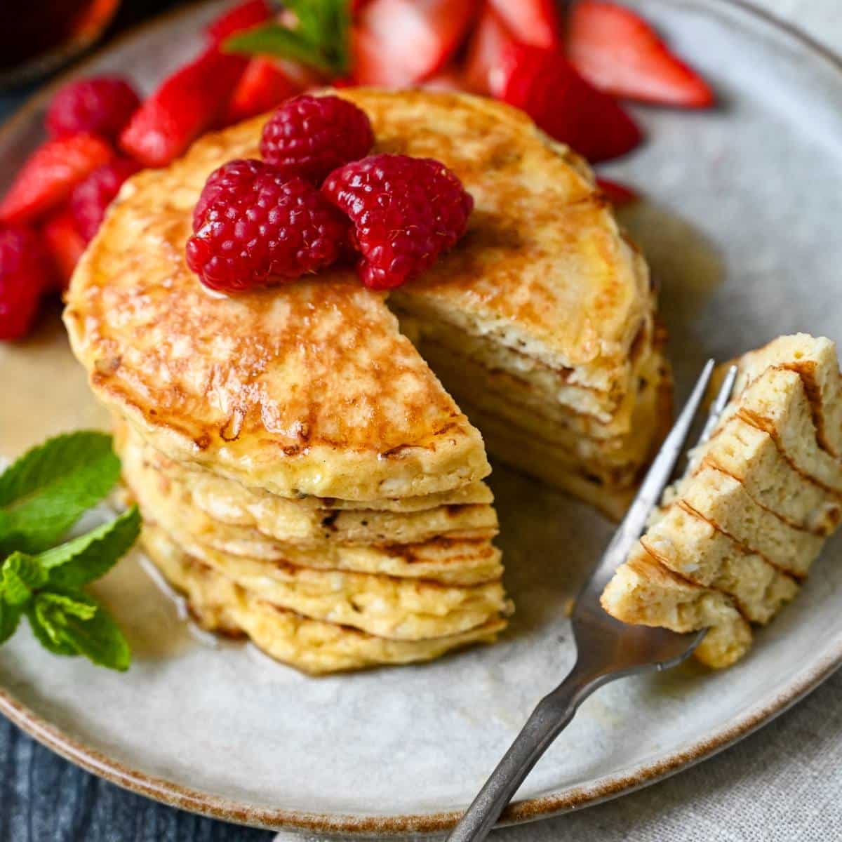 stack of pancakes with a section cut out on a fork