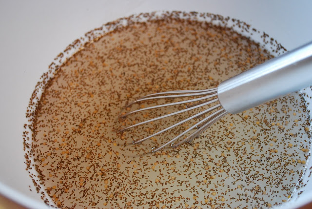 Brine for making cucumber pickles in a large bowl with a whisk