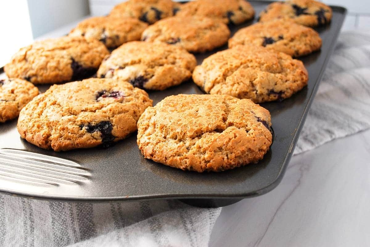 blueberry muffins in a muffin tin fresh from the oven