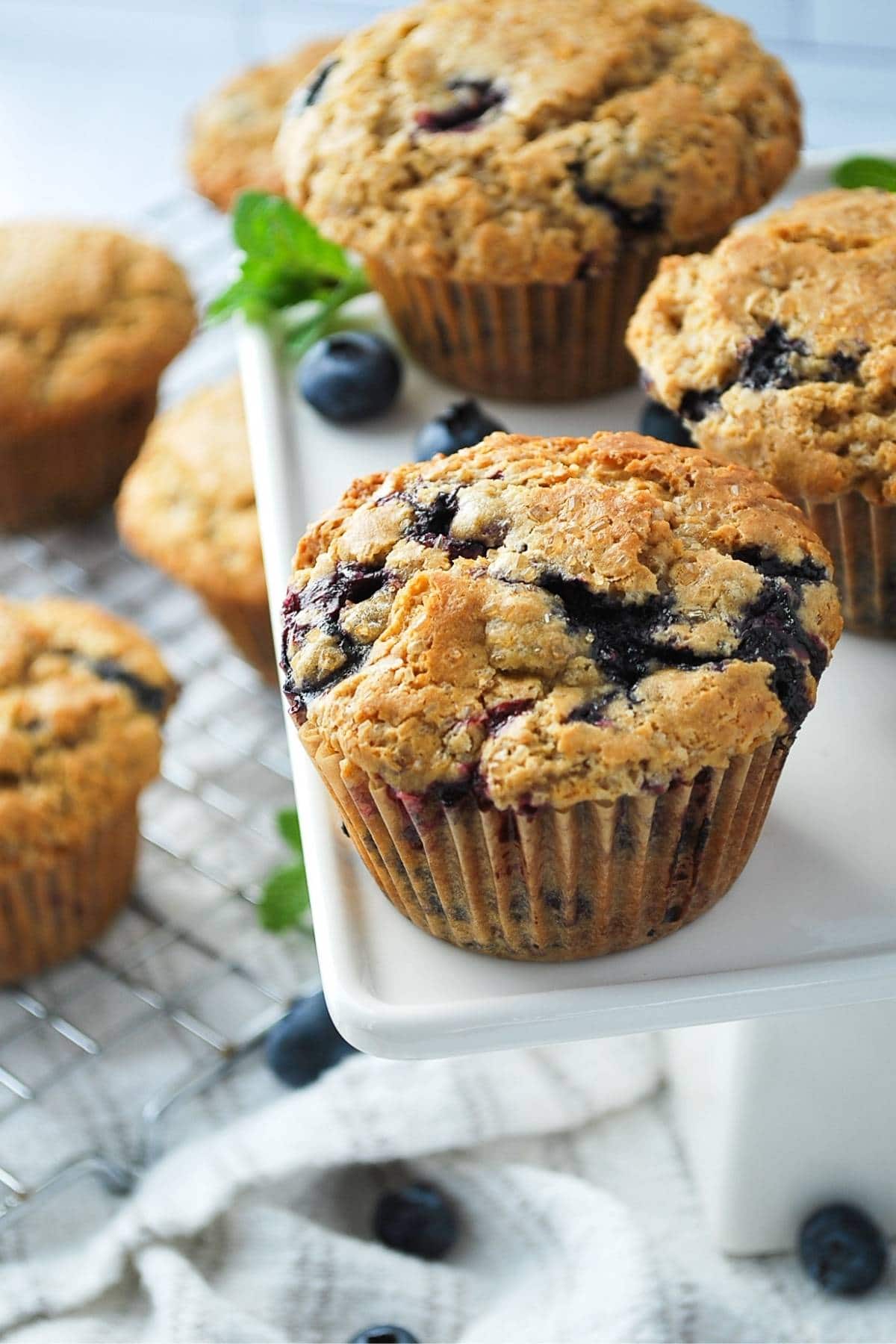 muffins on a platter with a rack of muffins underneath