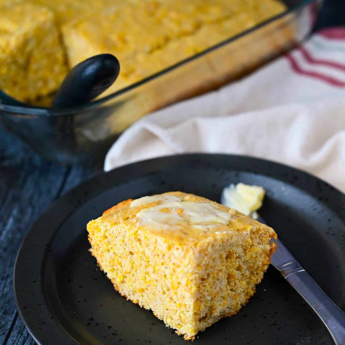 a square slice of cornbread with butter on top