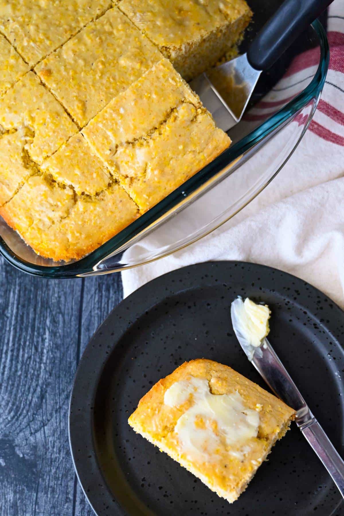 a pan of gf cornbread baked in a glass dish with a plate with a slice of cornbread