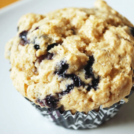 A blueberry muffin on a white plate