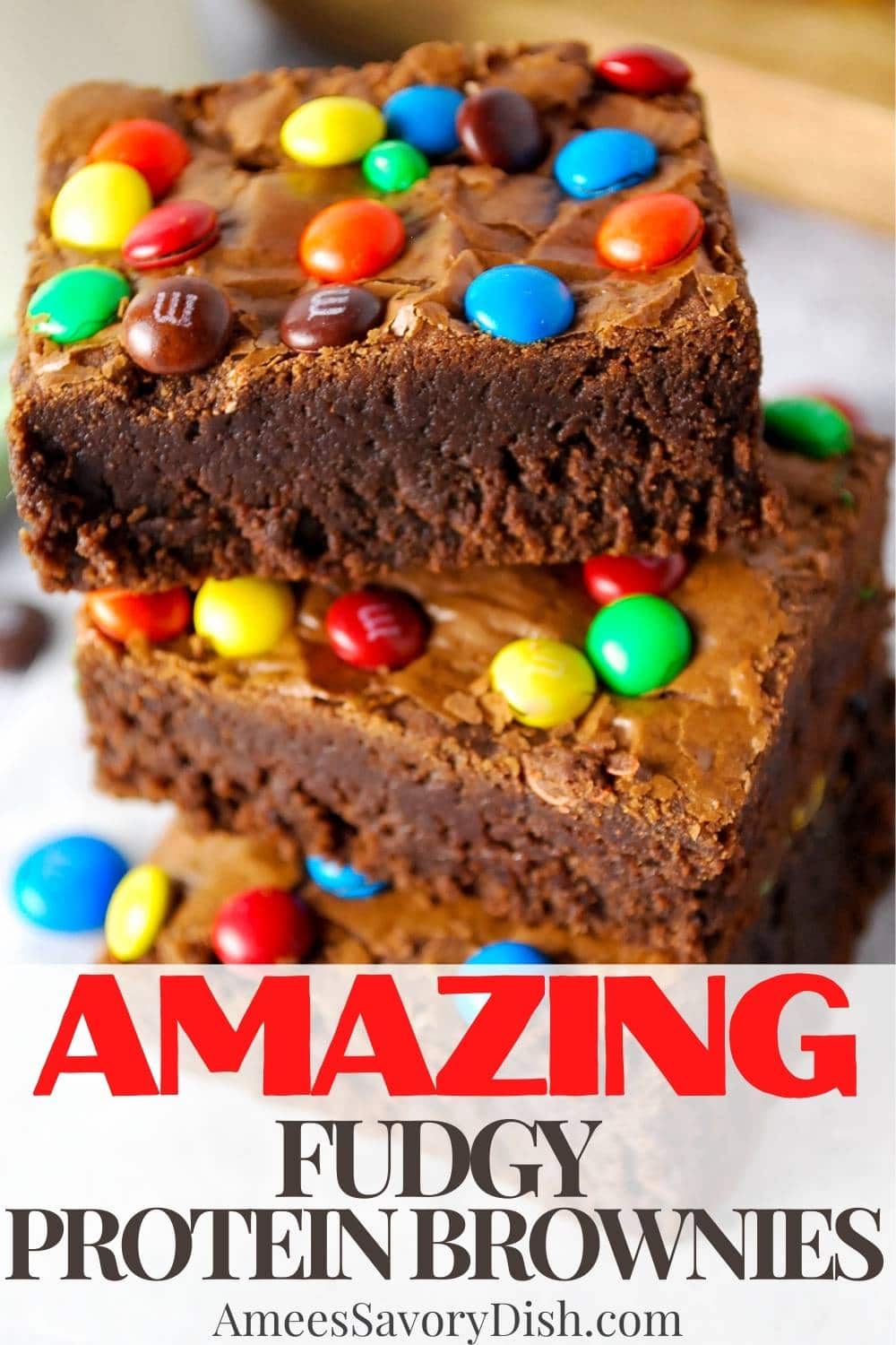 These fudgy protein brownies with M&M's are heavenly! Indulge in a thick, rich chocolate brownie while taking in an extra protein boost. via @Ameessavorydish