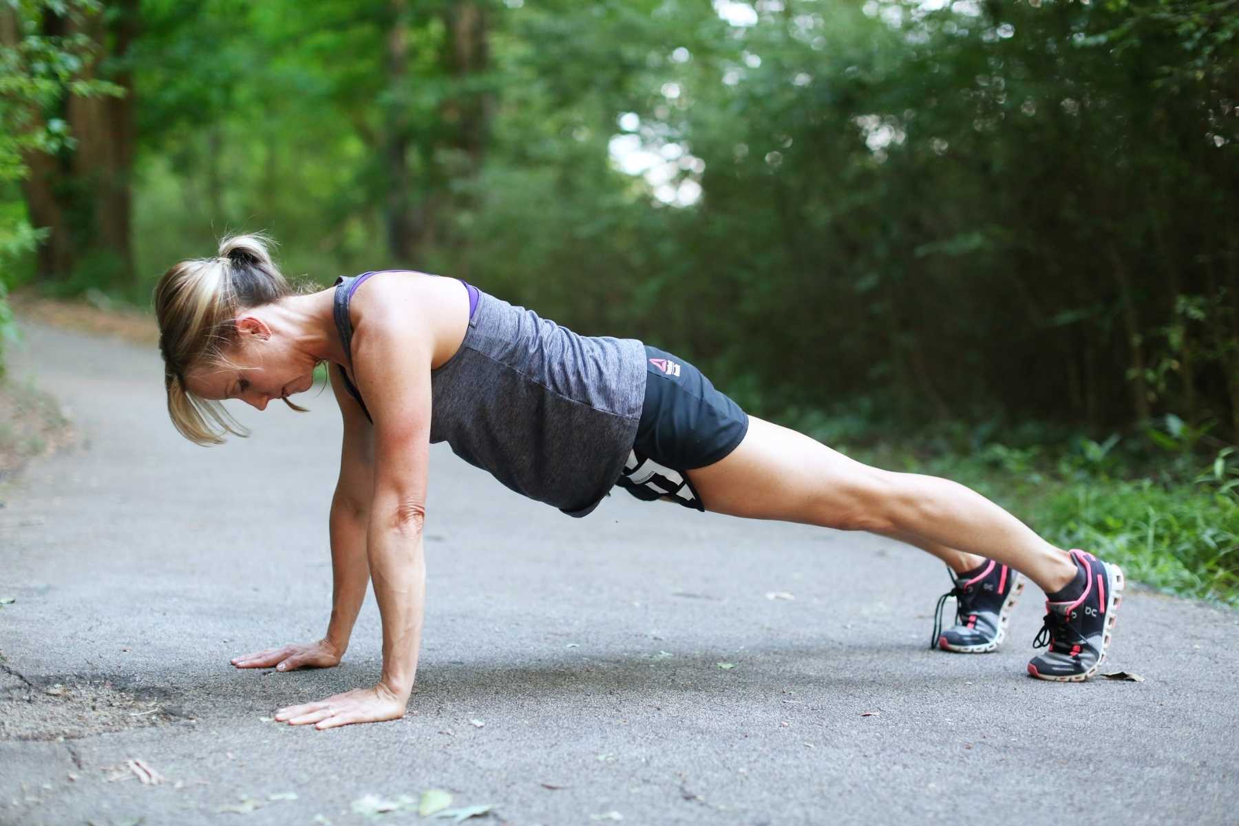 side view of woman in a plank on the street