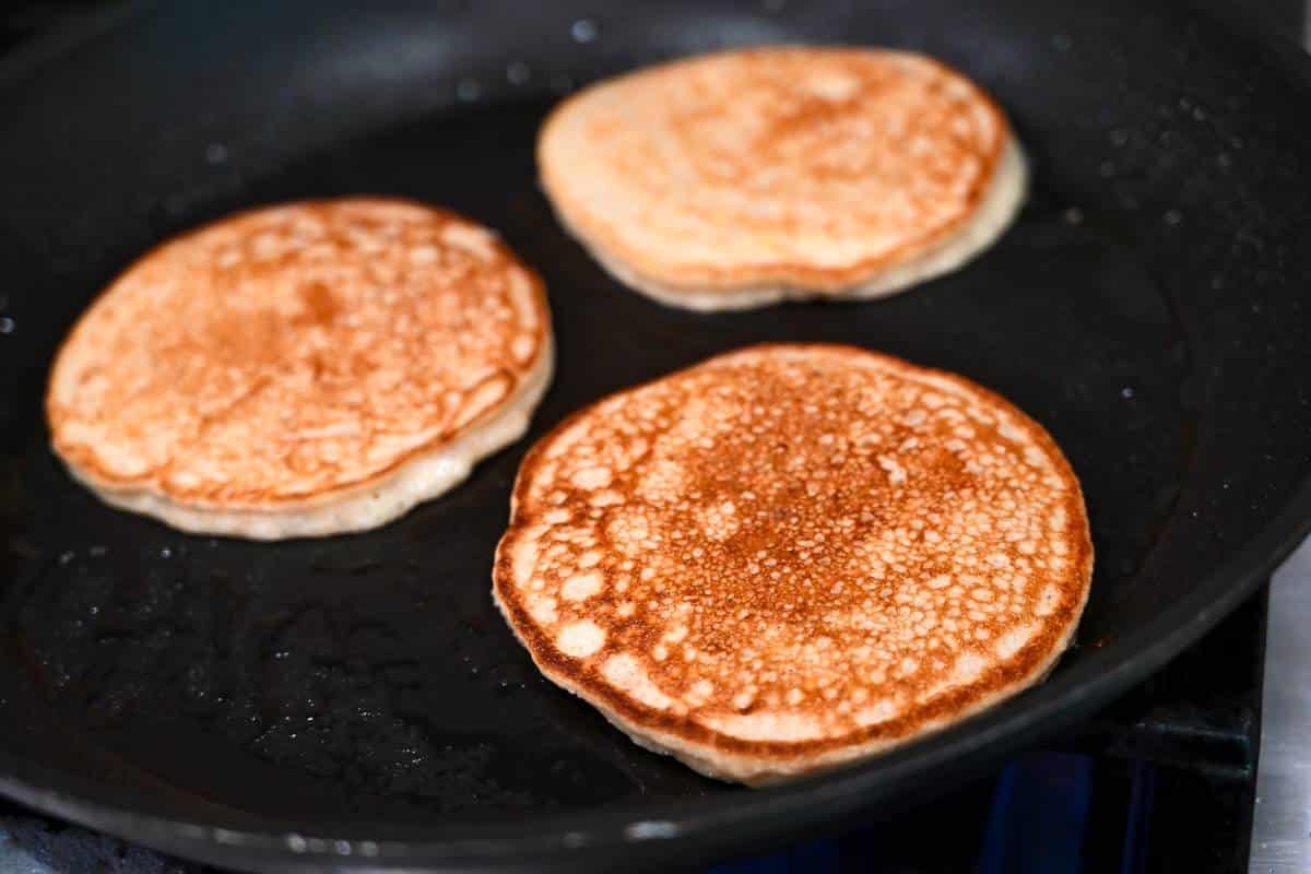 pancakes cooking in a skillet