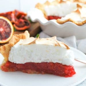close up of a slice of blood orange pie on a plate
