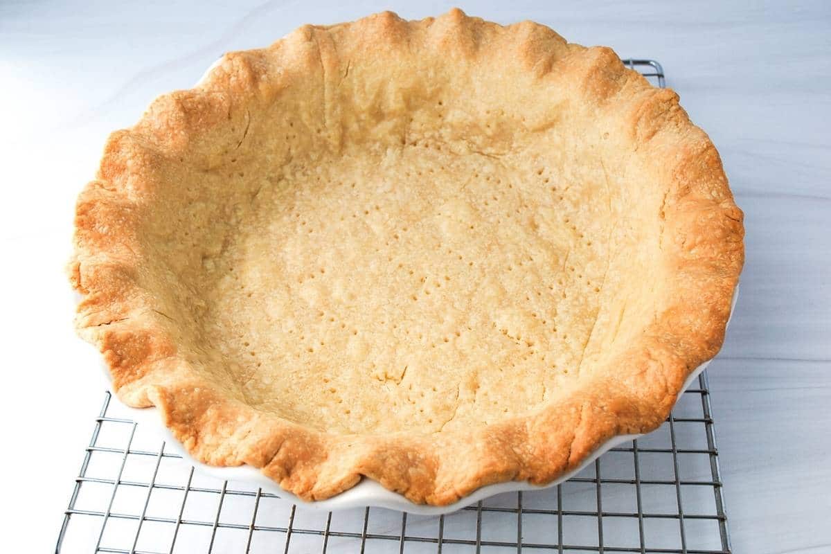 blind baked pie crust on a cooling rack