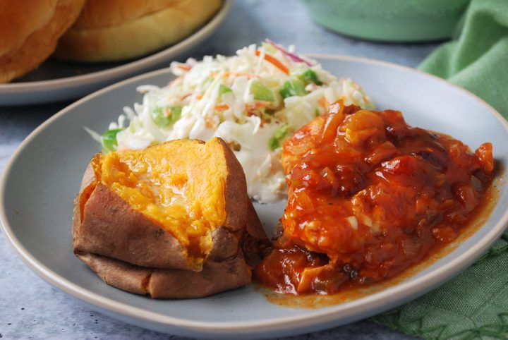 Crockpot bbq served on a plate with sides