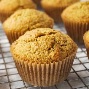 close up photo of a flaxseed muffin in a parchment liner