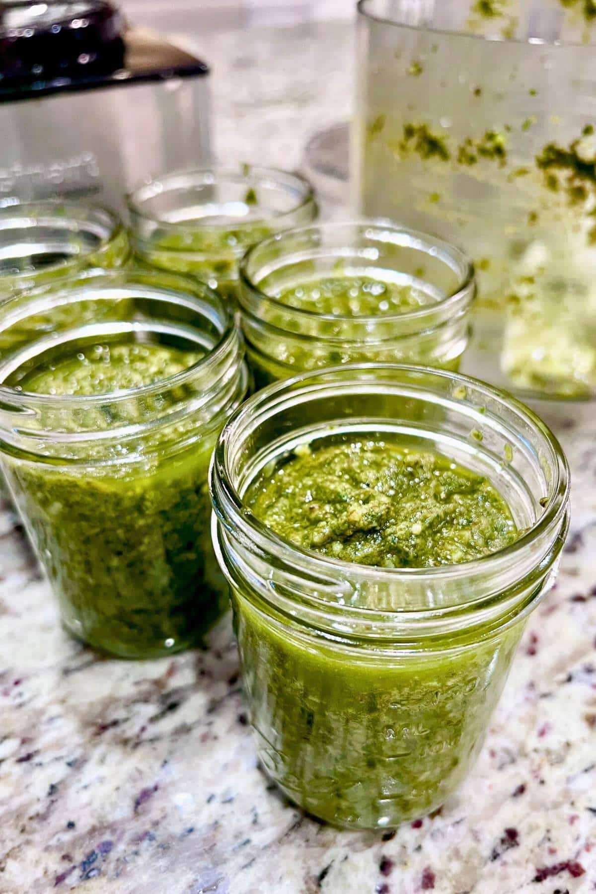 homemade pesto sauce in mason jars 
